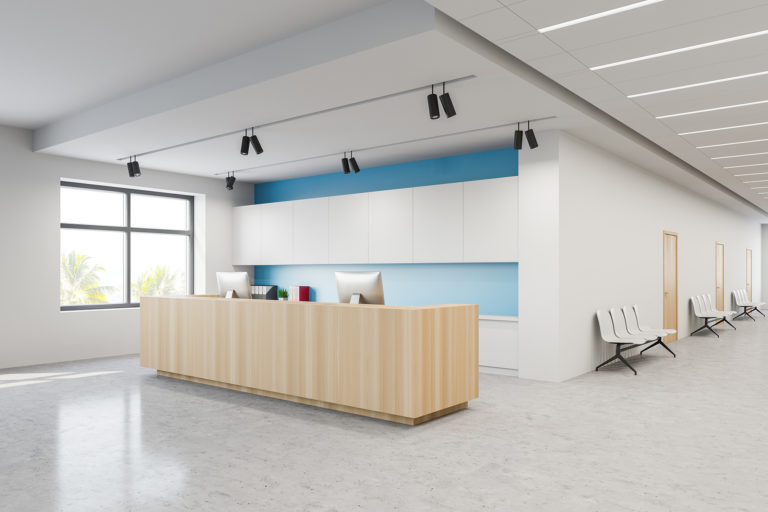 Reception and chairs in white blue hospital lobby