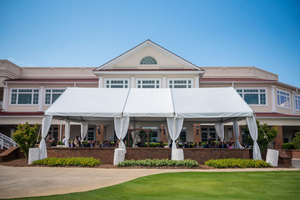 MARIETTA, UNITED STATES – Jun 14, 2021: White event tent captured outside country club building before an outdoor wedding ceremony